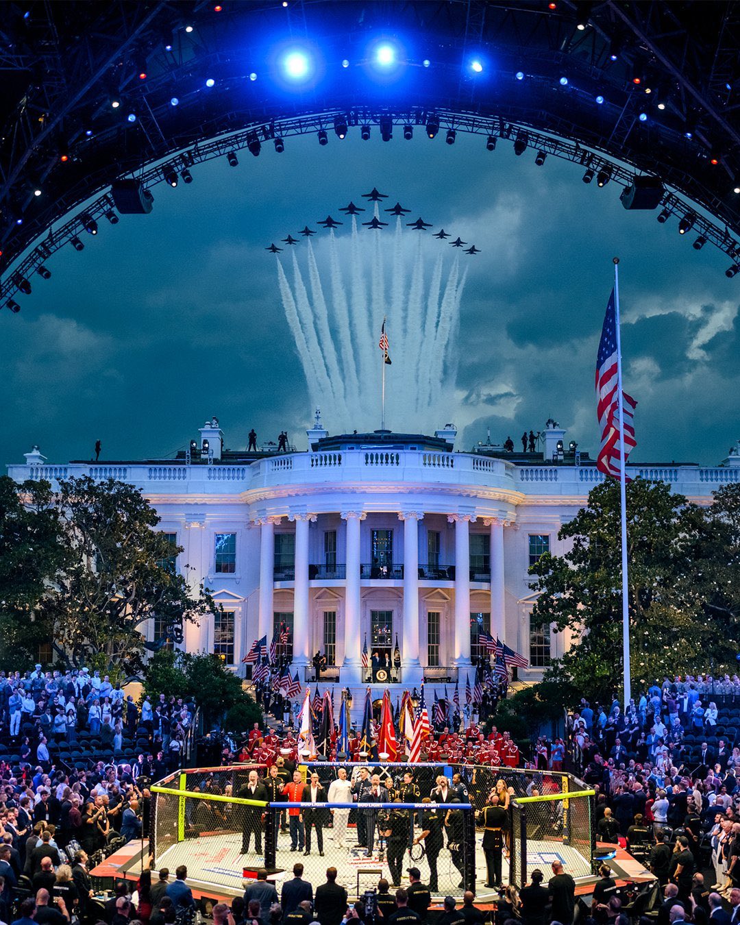 A single lone UFC octagon set up on a manicured estate lawn, draped in blank corporate banner cloth.