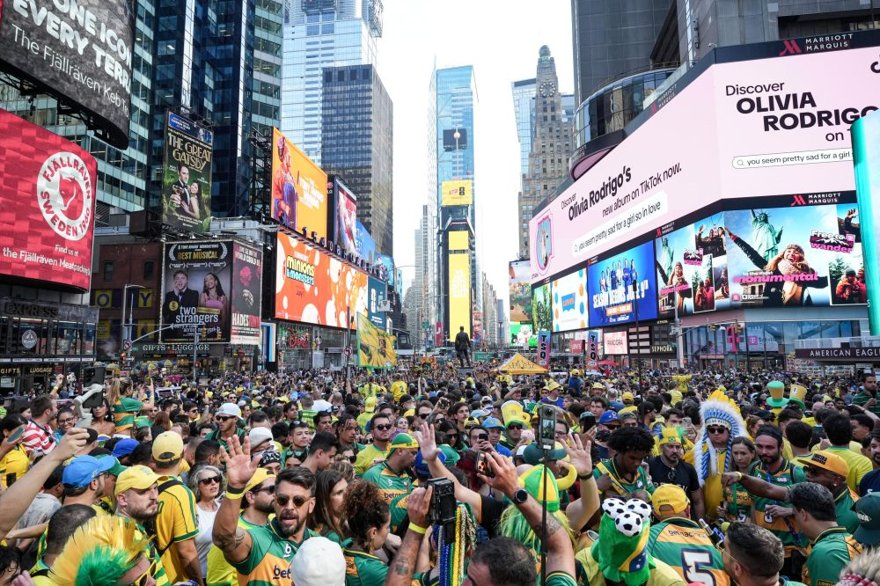 A single golden World Cup trophy on a cash register, with an empty city skyline holding the receipt.
