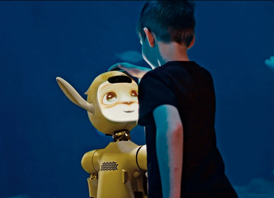 A single lone plush robot toy bobbing alone in the middle of a calm blue ocean, tiny distant shoreline, one clean subject, no text.
