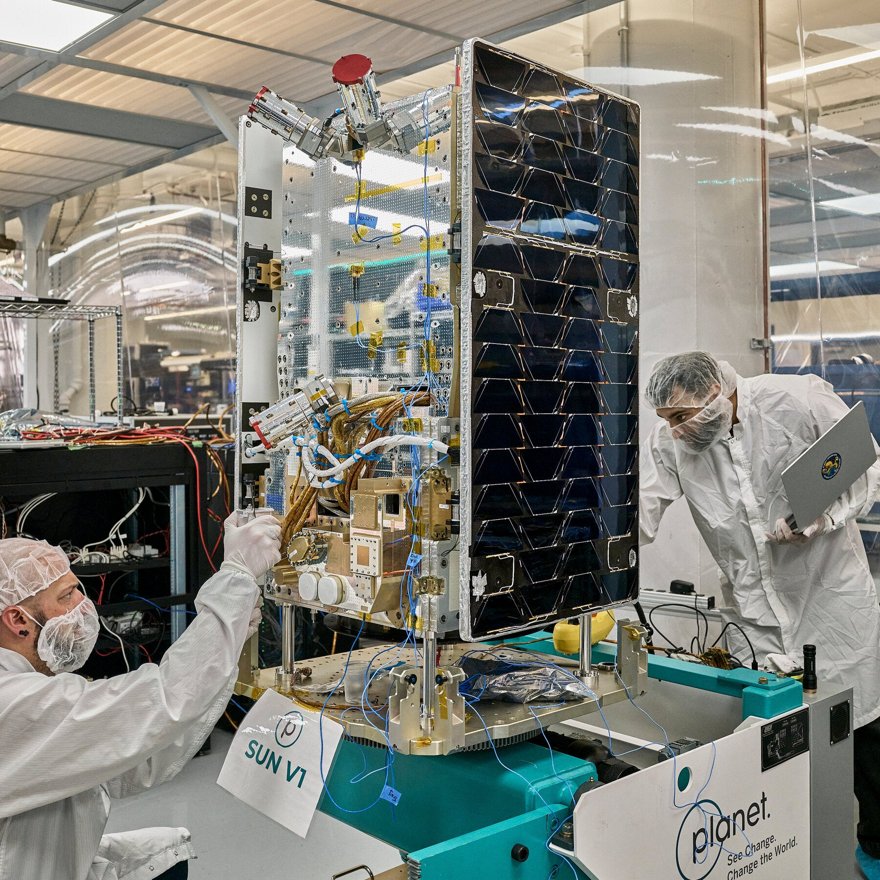 A single lone server rack floating in space with small solar panel wings, drifting peacefully past Earth.
